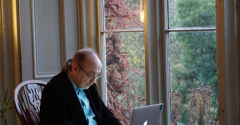 An elderly person using a laptop