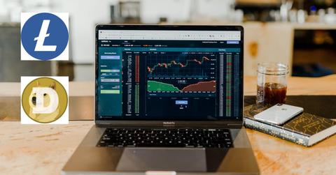 Laptop with data and Litecoin and Dogecoin logos