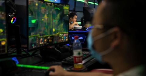 People gaming on computers wearing masks