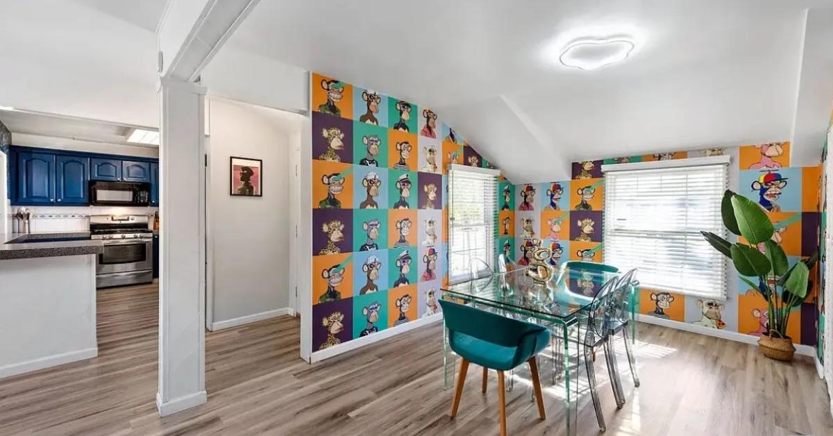 The inside of the ugly crypto house dining room with Bored Ape wallpaper.