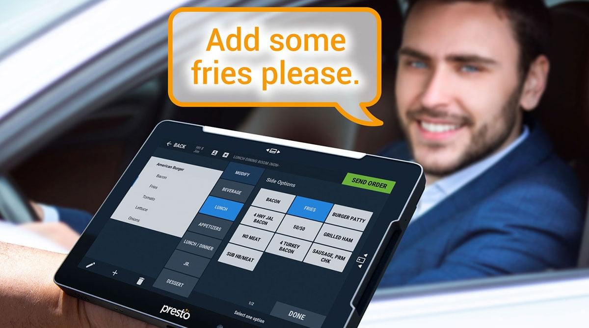 A customer adding fries to order using AI software