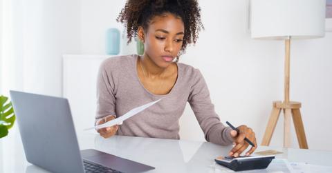 A woman calculating her student loan payment