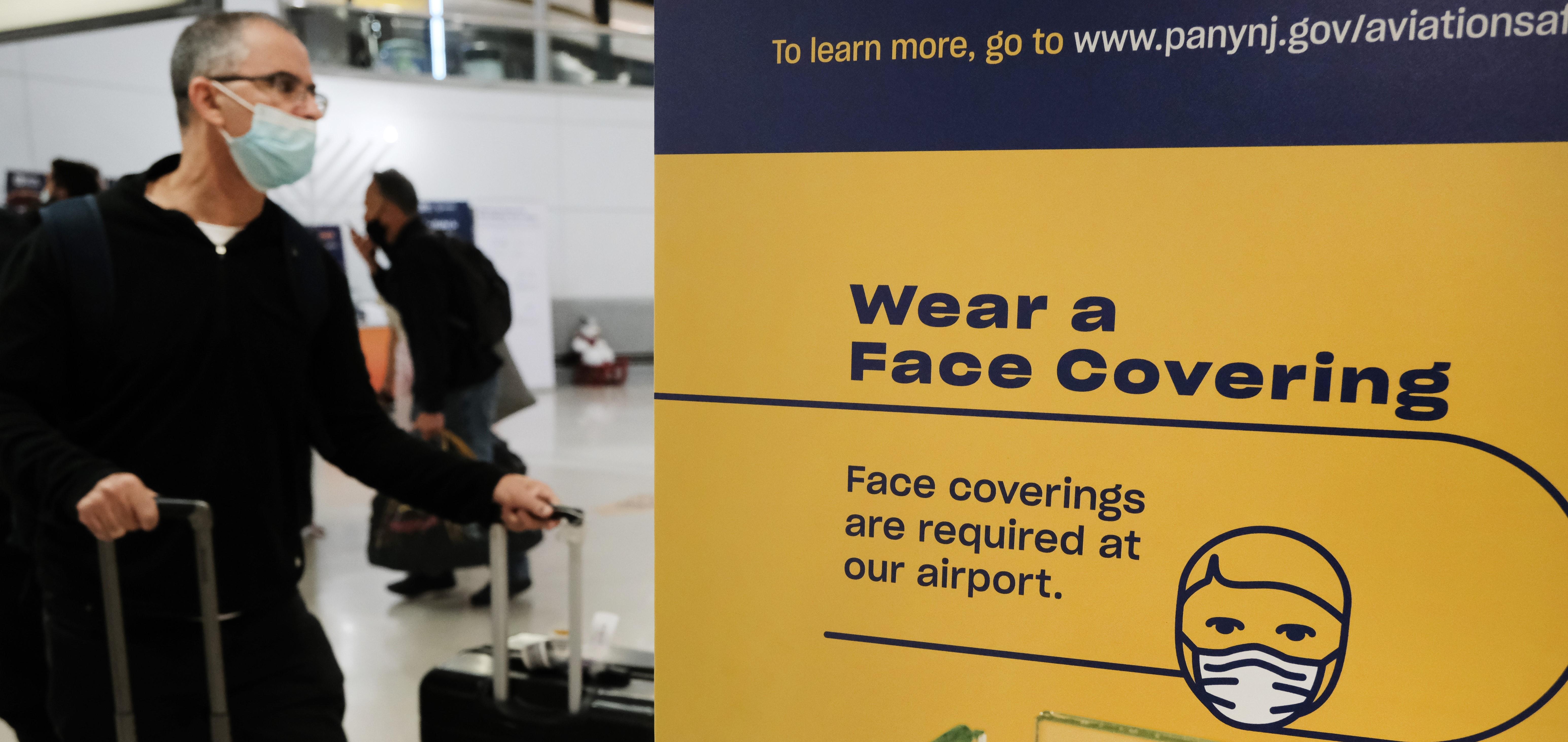 Face covering mask sign at airport after omicron announcement