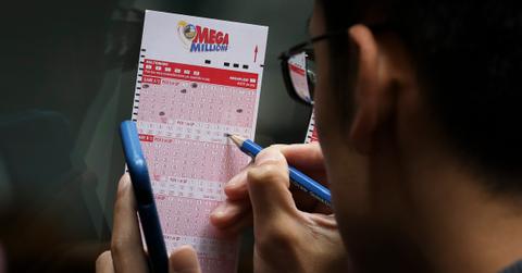 A personal filling out a Mega Millions ticket