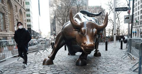 A man walking past the Wall Street Bull