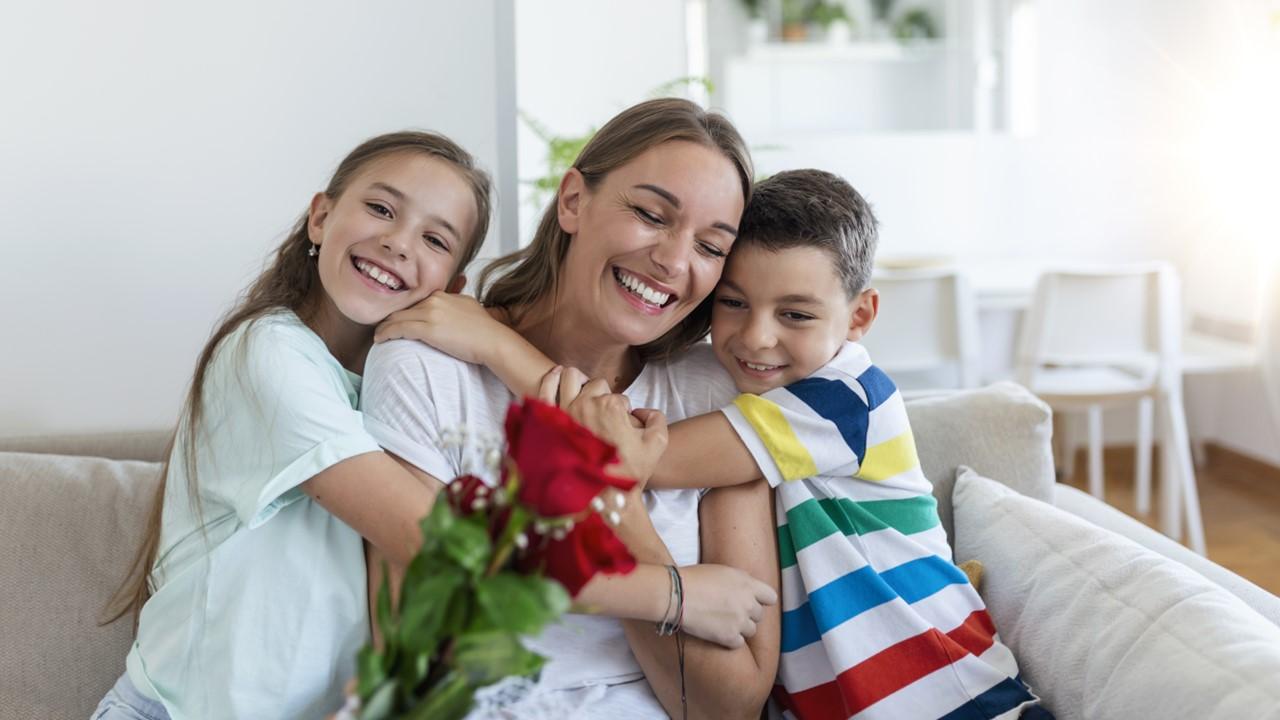 Kids giving their mom flowers on Mother's Day