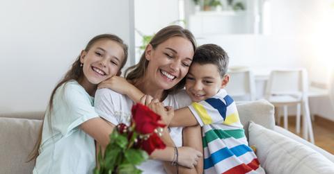 Kids giving their mom flowers on Mother's Day