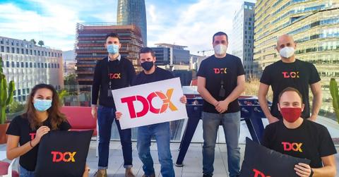 People posing in TDCX T-shirts on a rooftop