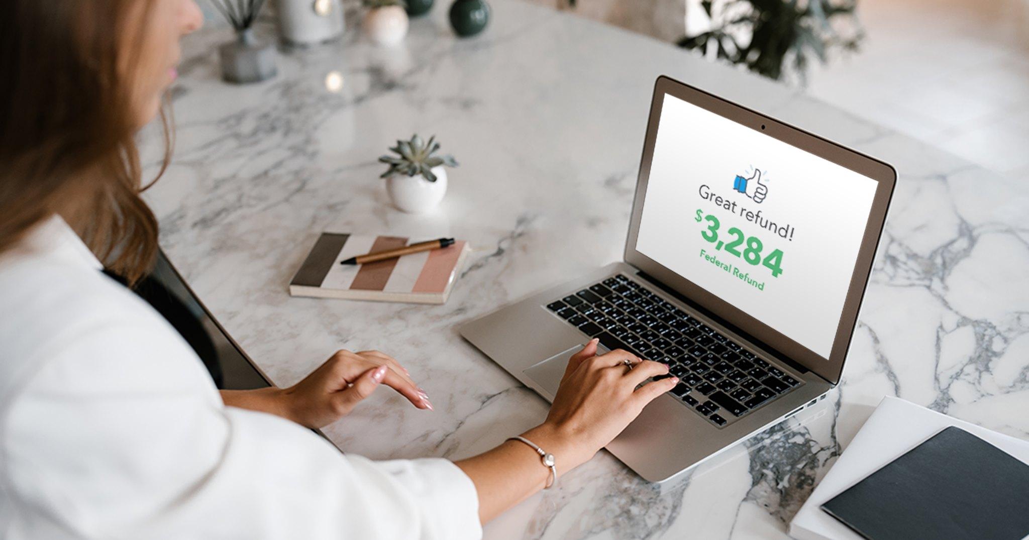 A person checking a federal tax refund on a laptop