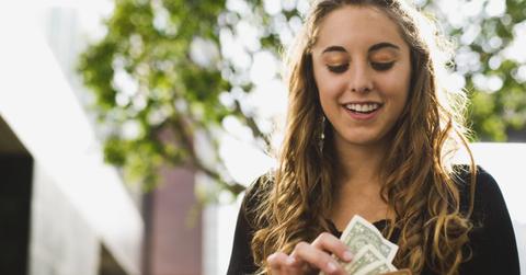 A woman getting paid cash