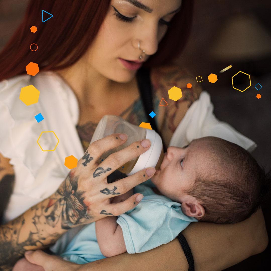 mother feeding a baby enfamil