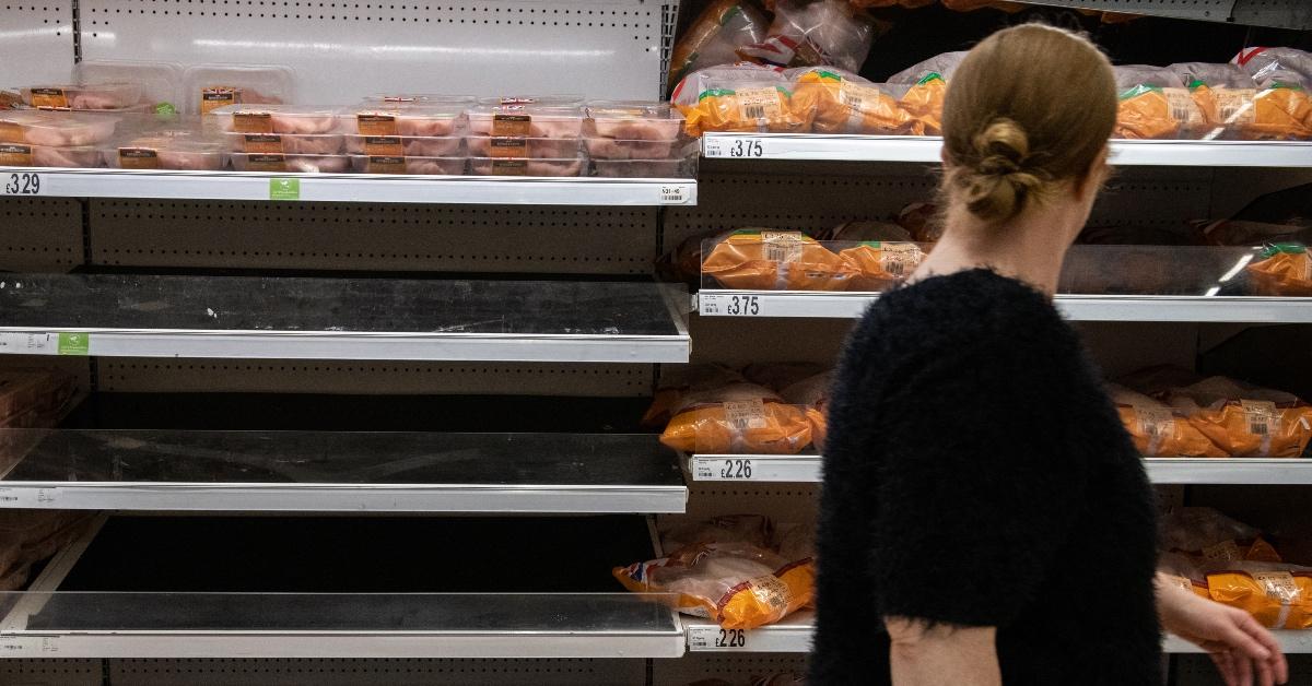 Empty frozen chicken shelves at a grocery store