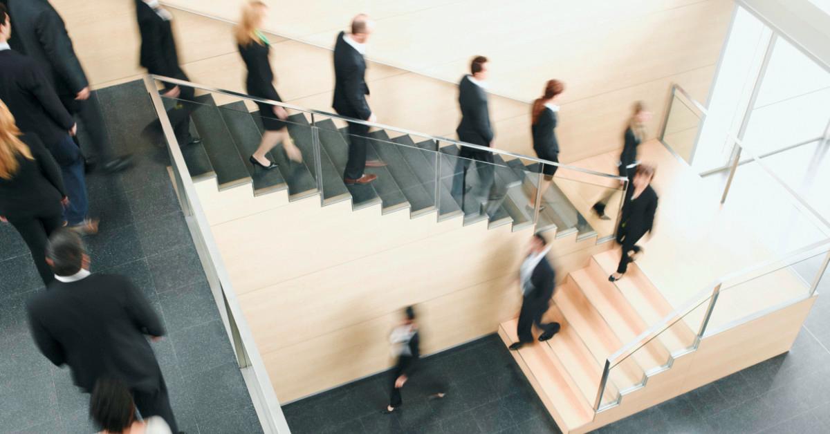 Workers descending staircase