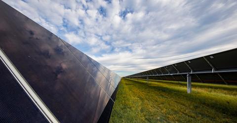 Solar panels on a sunny day in a grassy field