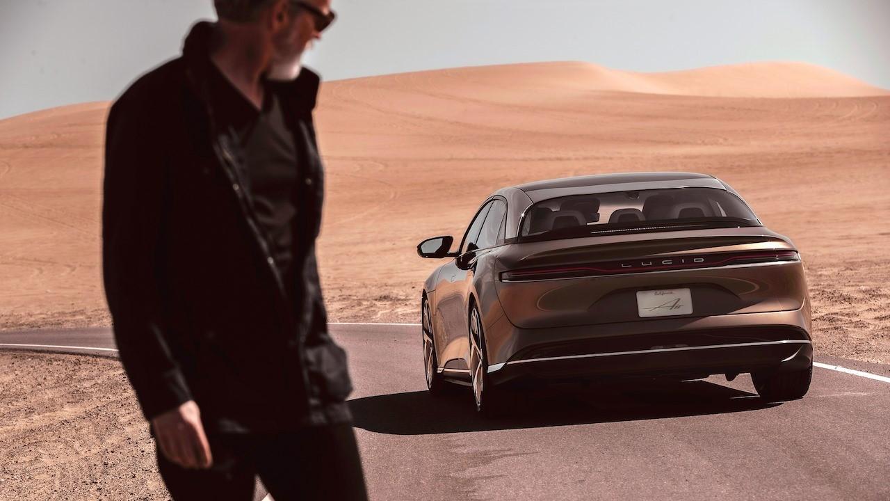 Man looking at a Lucid Air