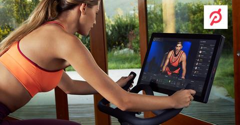 A woman using a Peloton bike and the Peloton logo