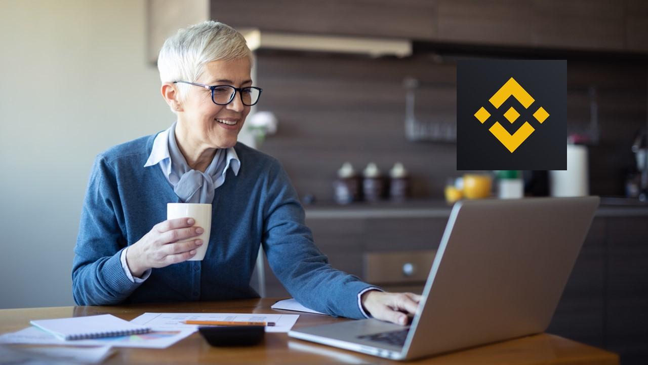 Woman looking on a laptop and Binance logo