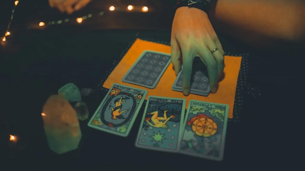 A tarot card reader using cards on a table