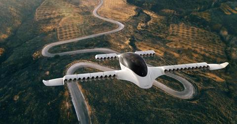 An urban aircraft flying over a winding road