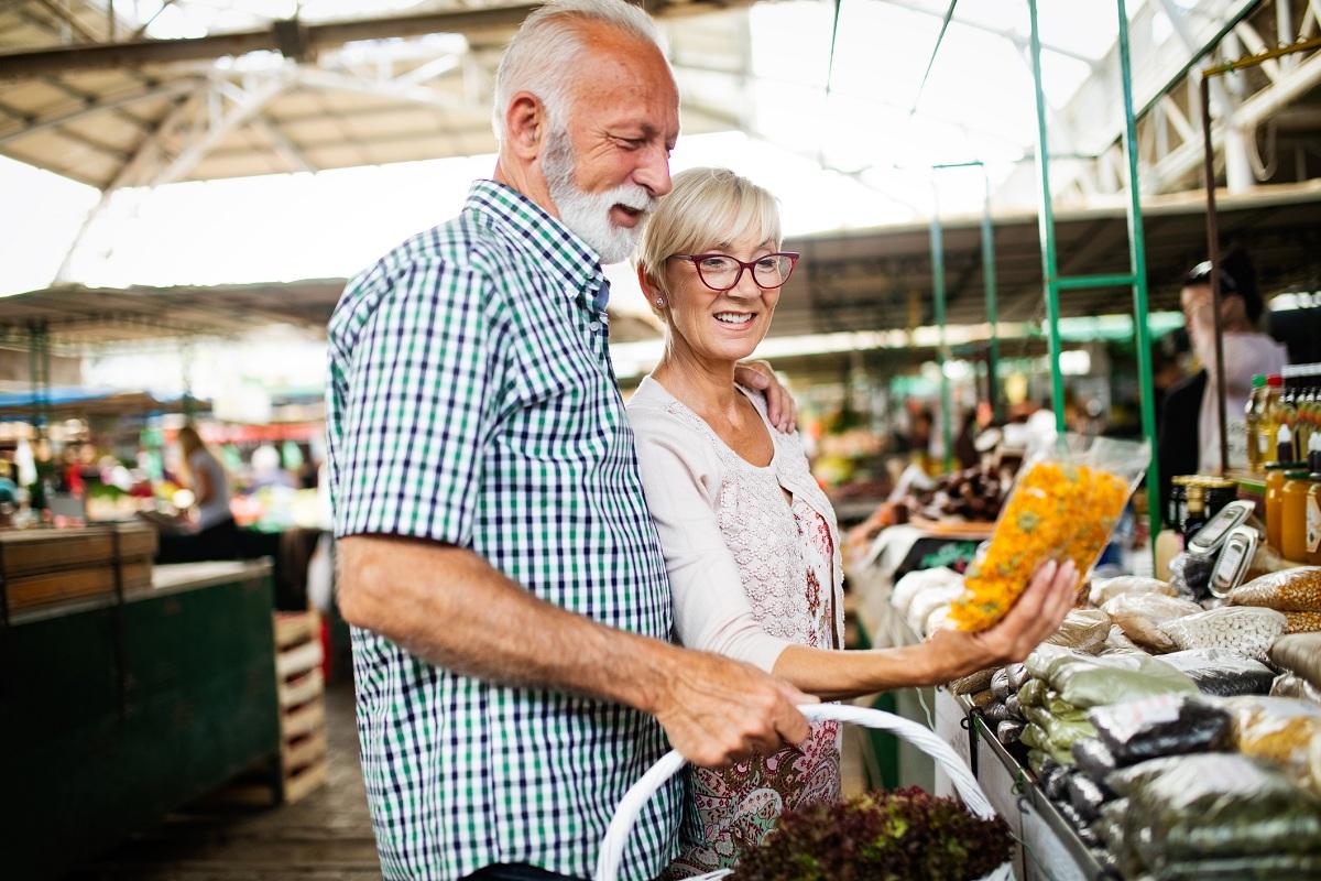 A senior couple shopping for food 