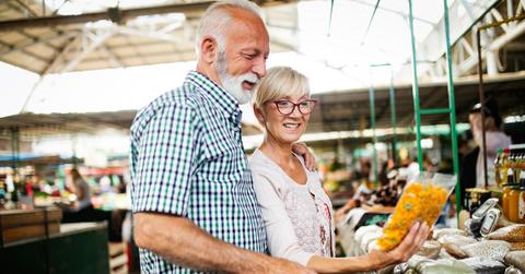 A senior couple shopping for food