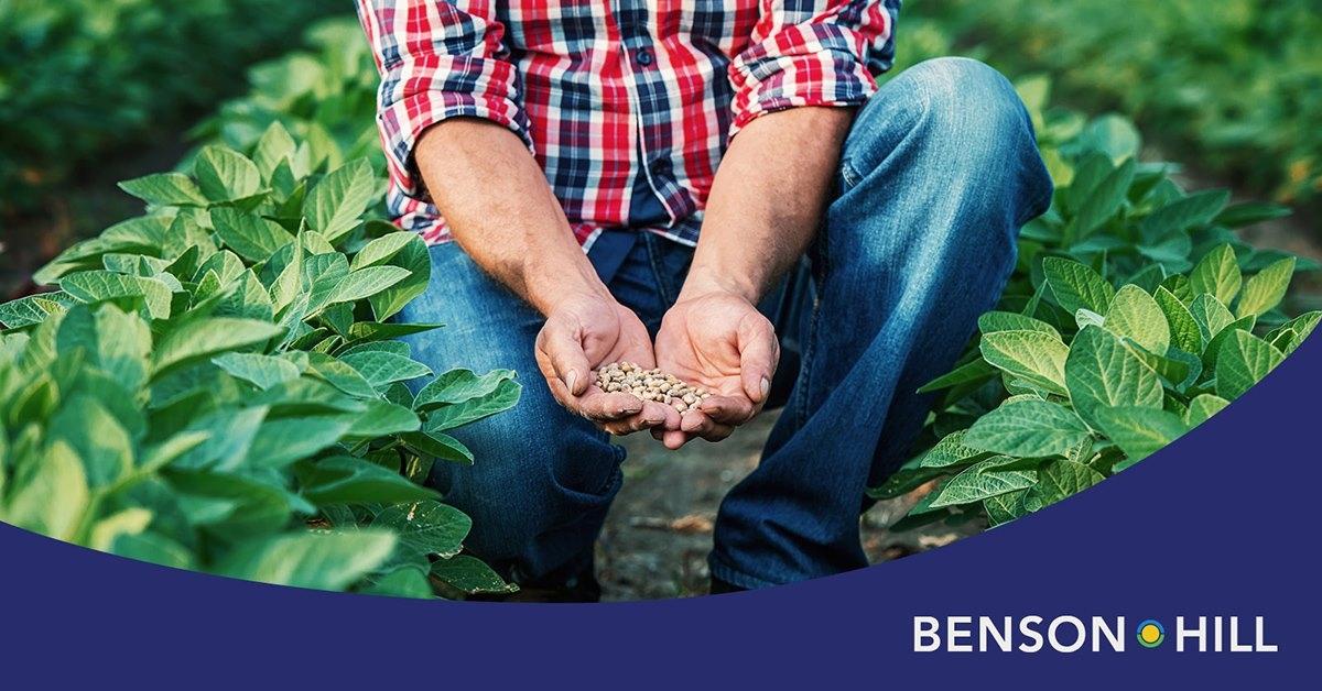 Man holding seeds and Benson Hill logo