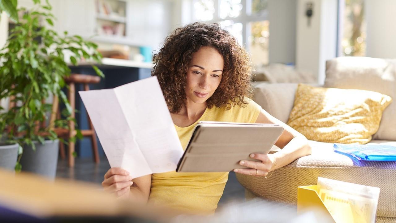 Woman looking at stock data on a tablet