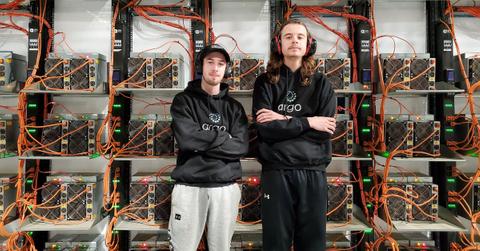 People posing in front of Argo Blockchain servers
