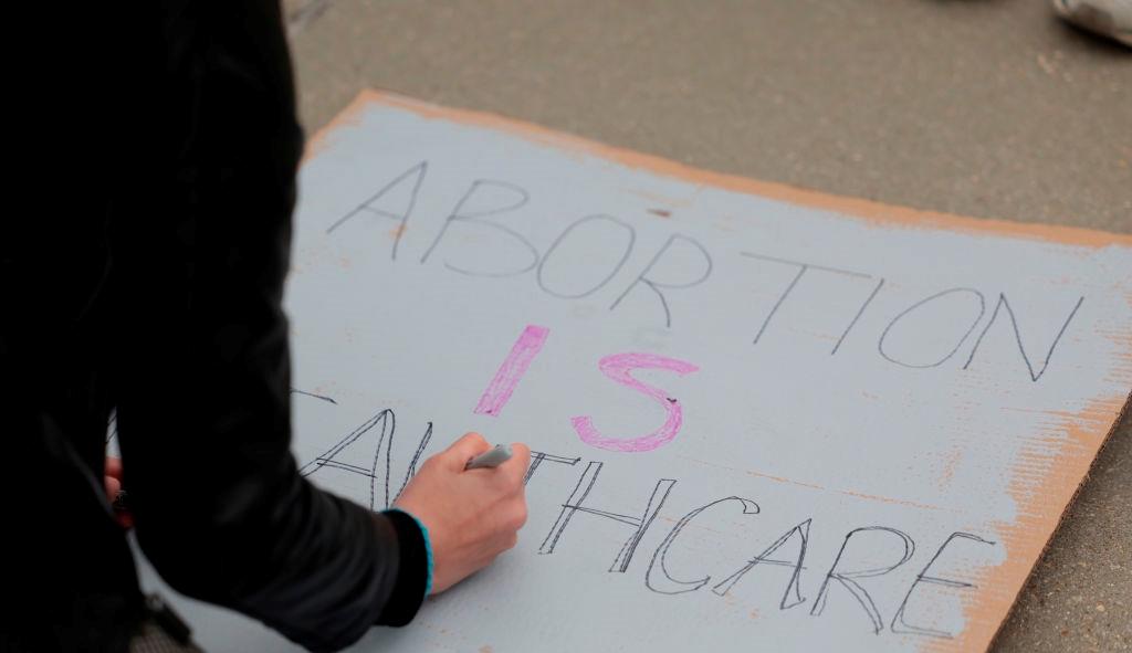 A person making an abortion protest sign