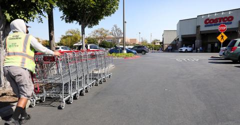 A worker collecting carts in front of Costco