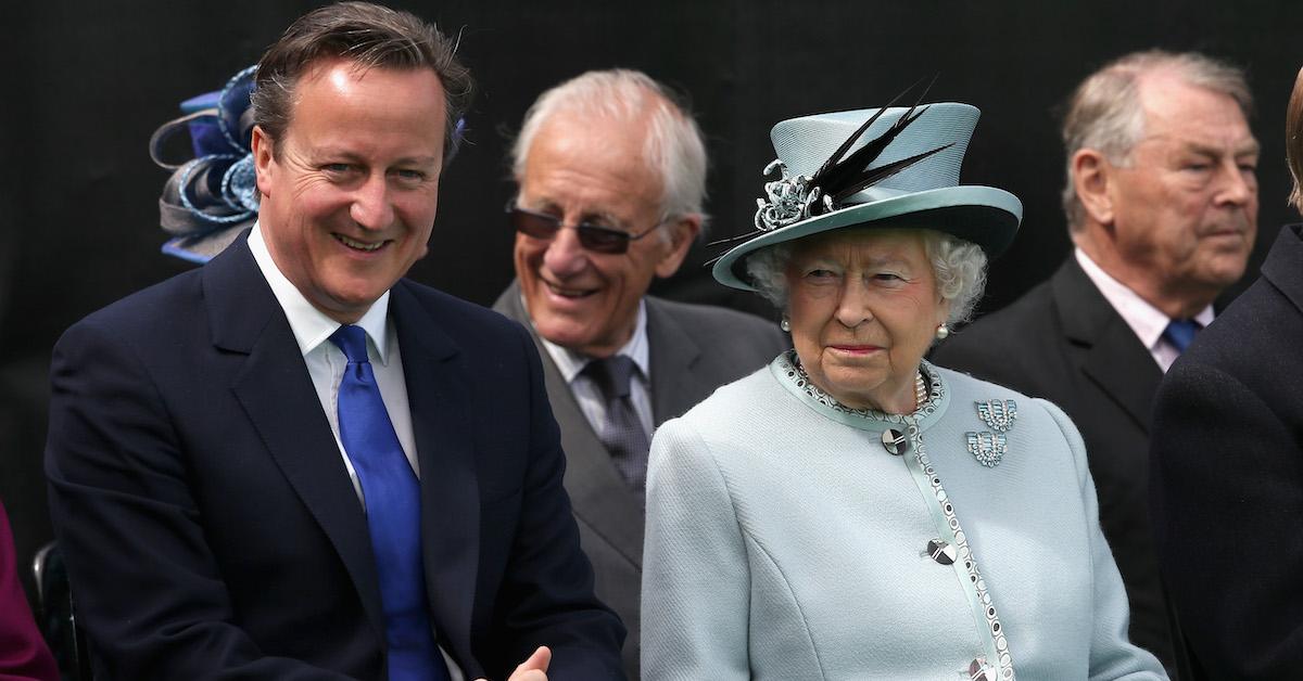 David Cameron sitting beside Queen Elizabeth II.