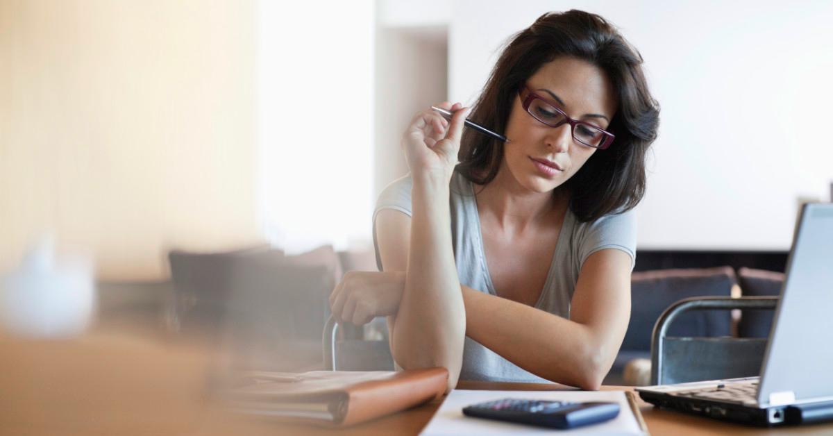 Woman using calculator