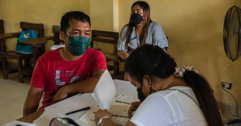 Voters register before casting their vote for the 2022 presidential election.