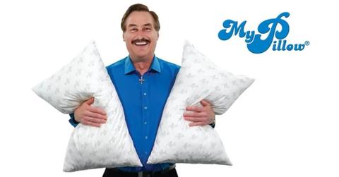 MyPillow CEO Mike Lindell holding two pillows.