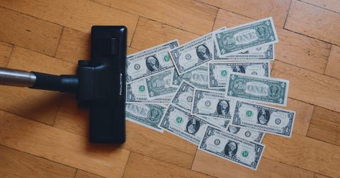 Dollar bills being vacuumed