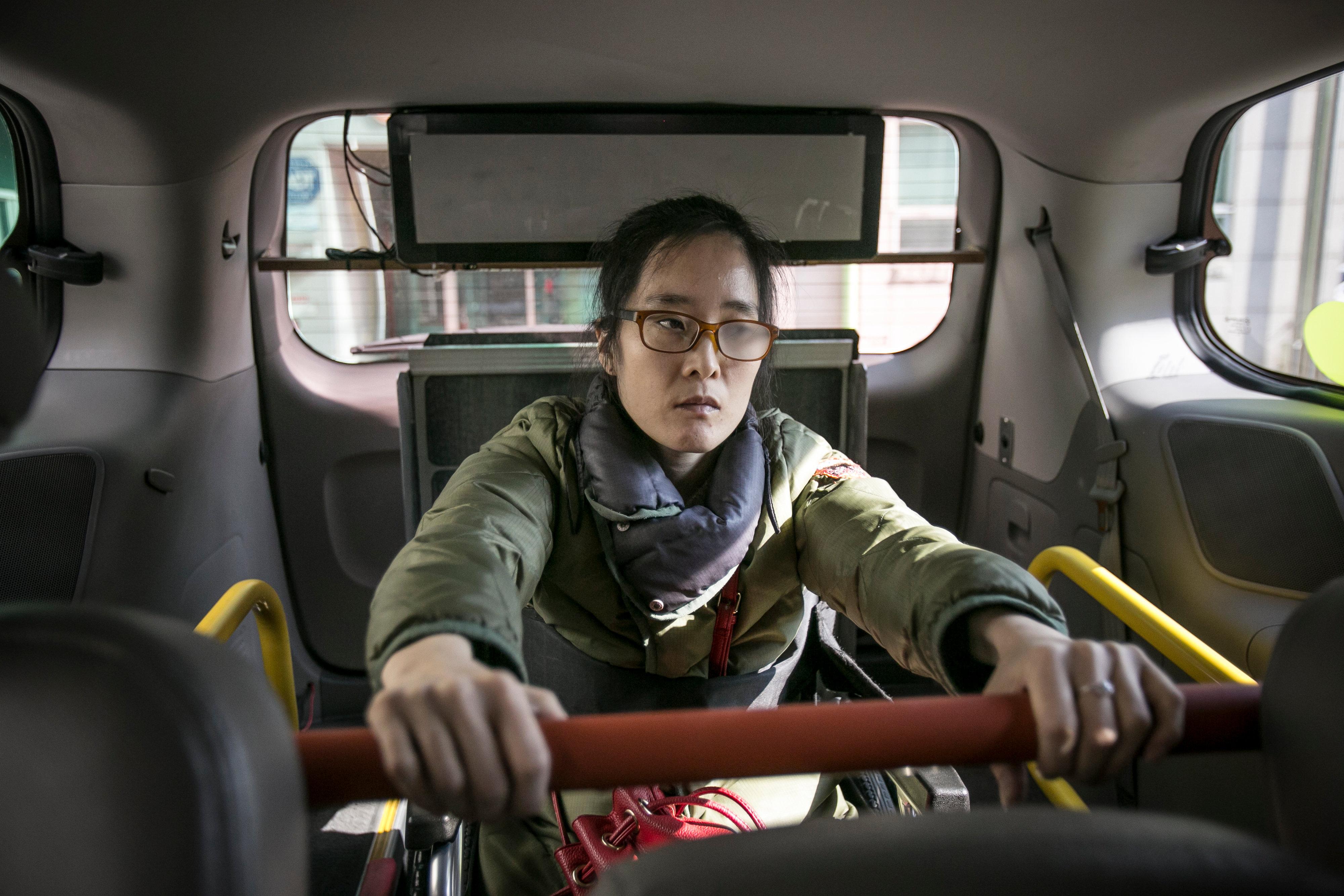 Woman in wheelchair in an accessible taxi