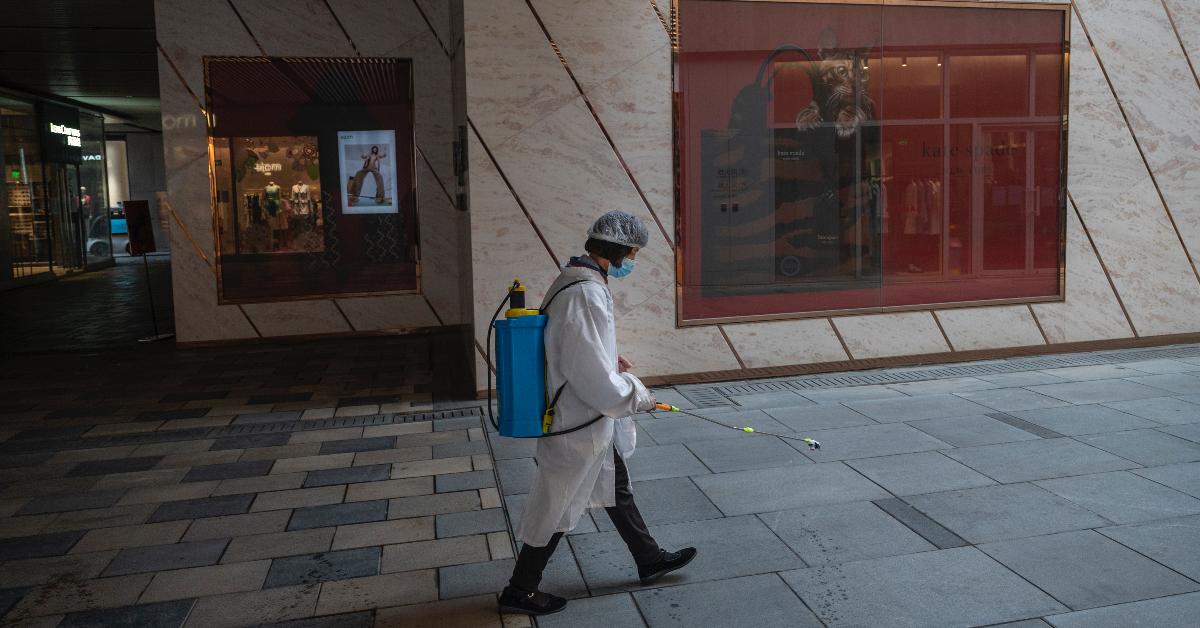 A worker disinfects the walkway