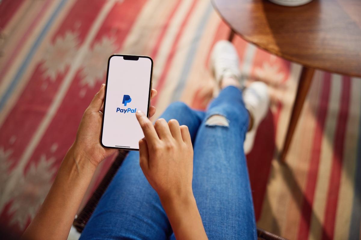 A woman using the PayPal app