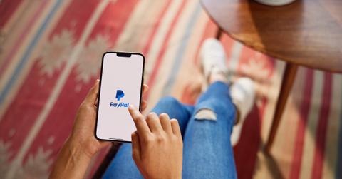 A woman using the PayPal app