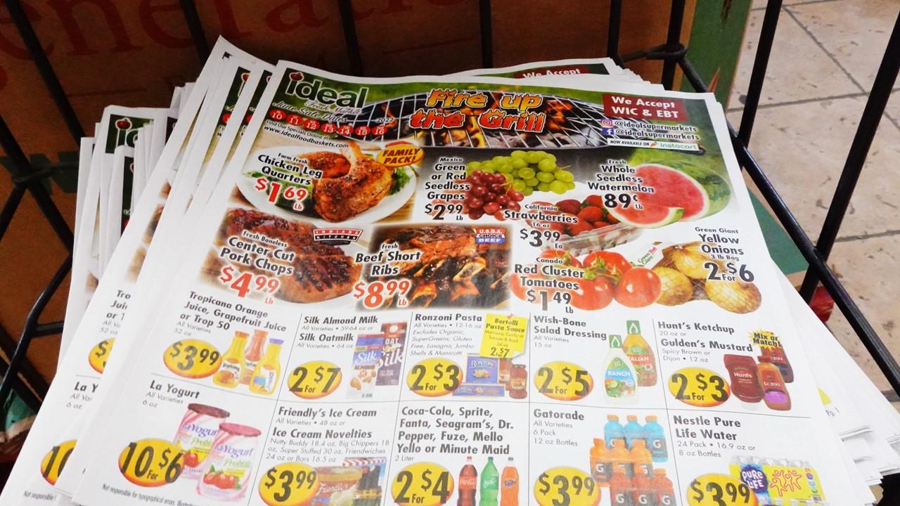 A stack of grocery store flyers