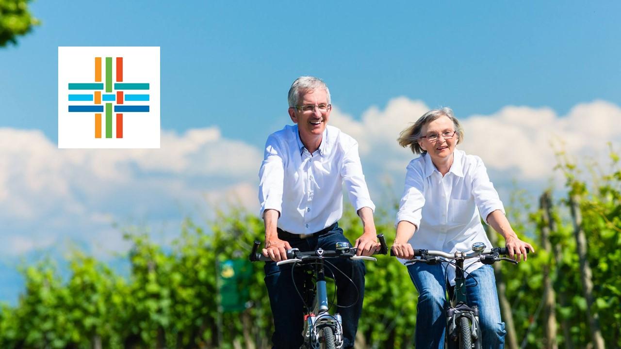 Couple riding bikes and Alignment Healthcare logo