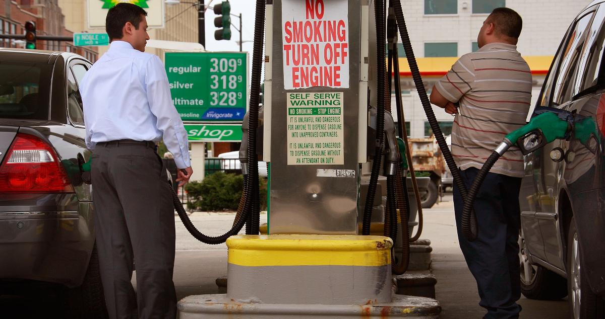 People filling their vehicles at a gas station