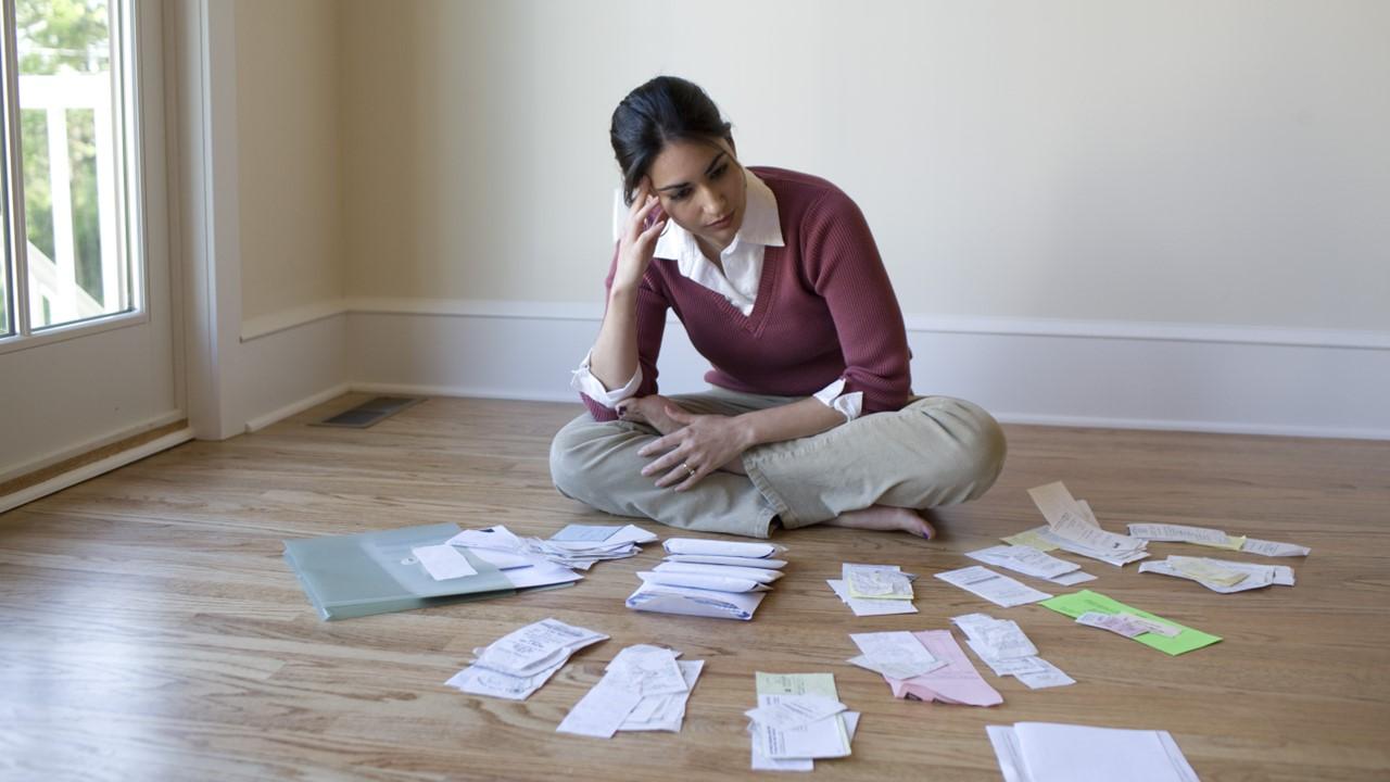 A woman looking at receipts and tax documents