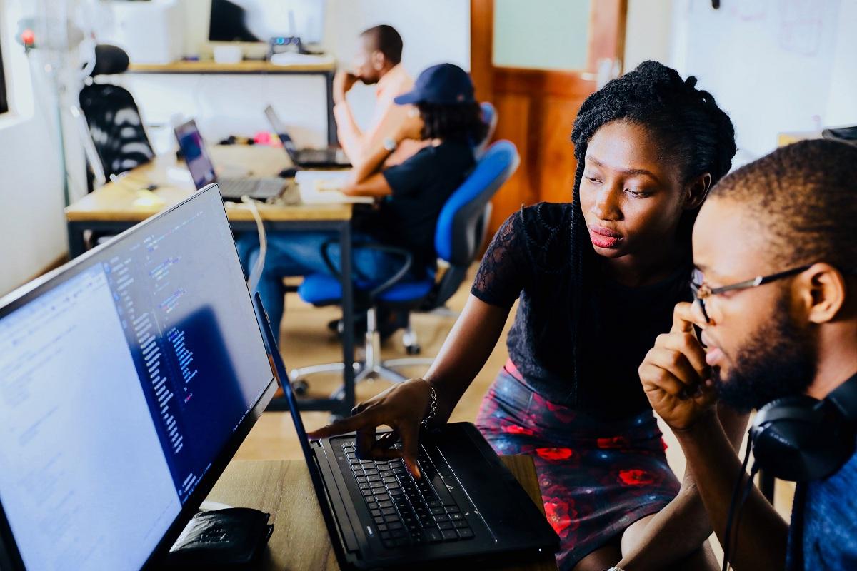 People looking at information on a computer screen