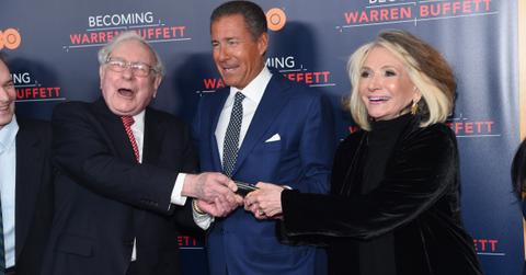 Warren Buffett laughing with others at an event