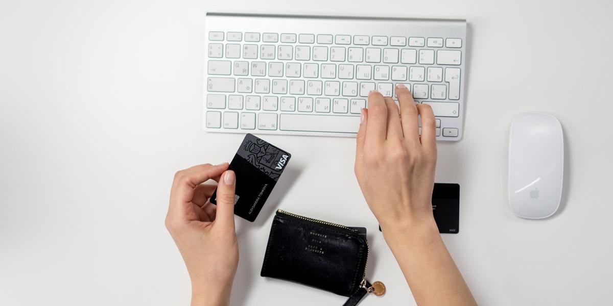 A person entering credit card information on a laptop