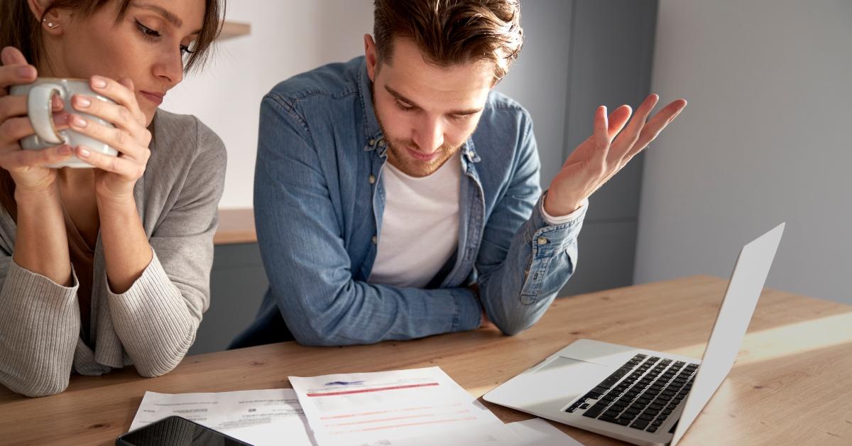 A couple looks over their bills.