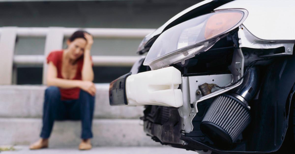 Woman with damaged car