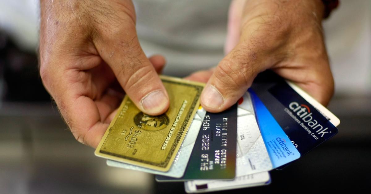 A man holding a stack of credit cards