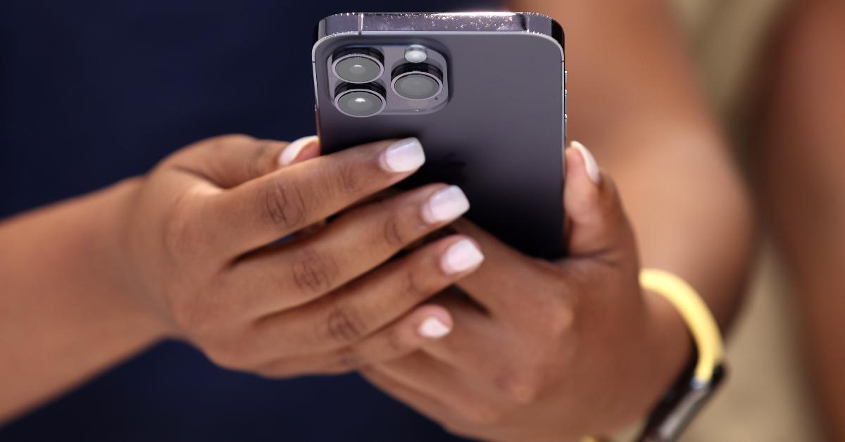 A woman holding a refurbished phone